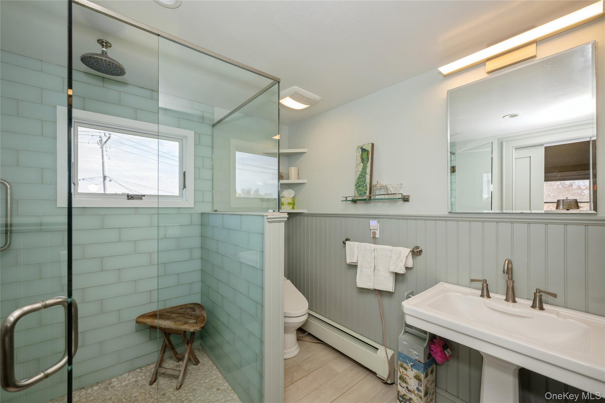 155 Essex Street Montauk, NY 11954 - Photo 9 of 11 a bathroom with a sink and a mirror