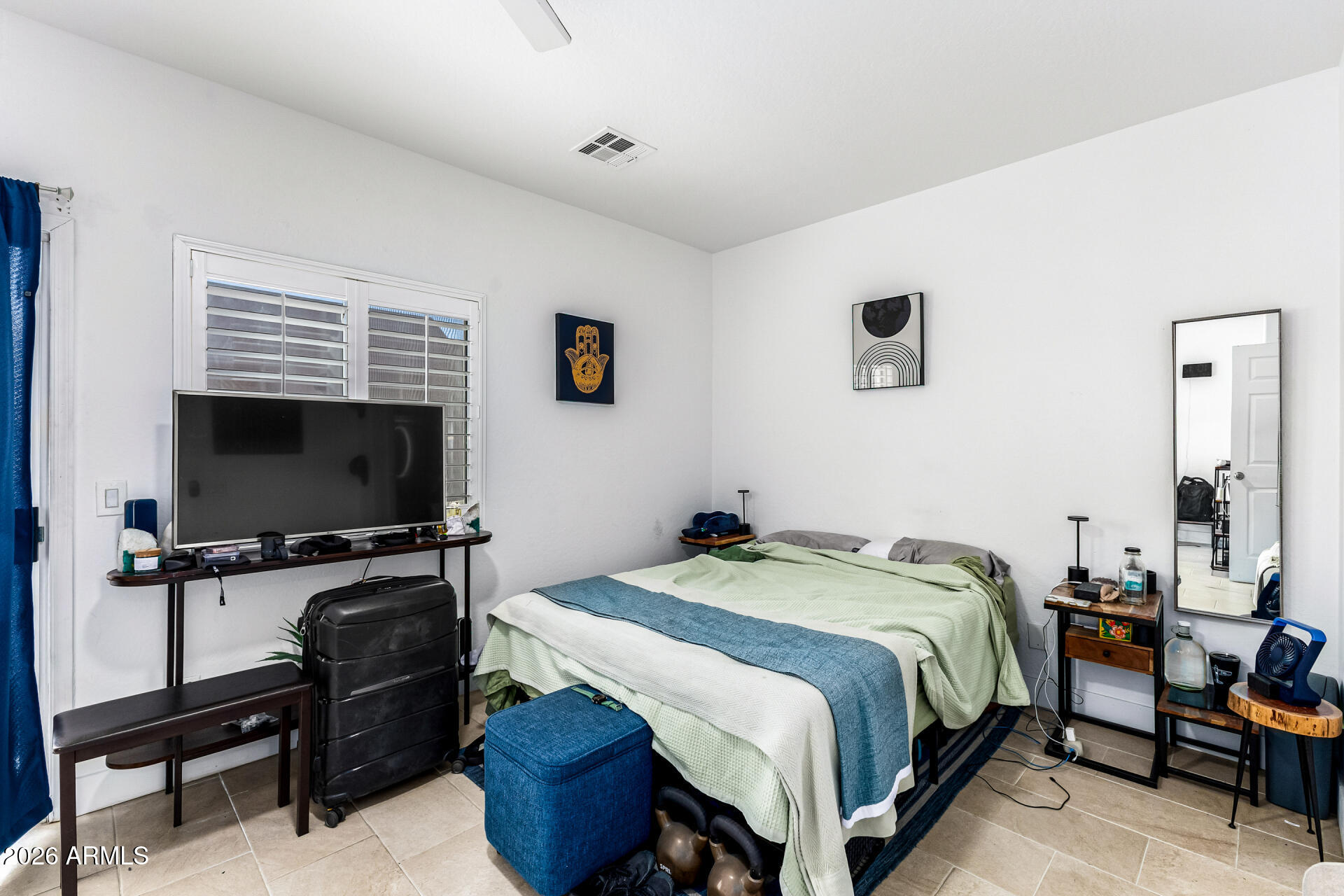 1718 West Colter Street, Unit 115 Phoenix, AZ 85015 - Photo 16 of 26 a bedroom with a bed and a flat screen tv