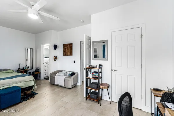 a bedroom with furniture and a large mirror
