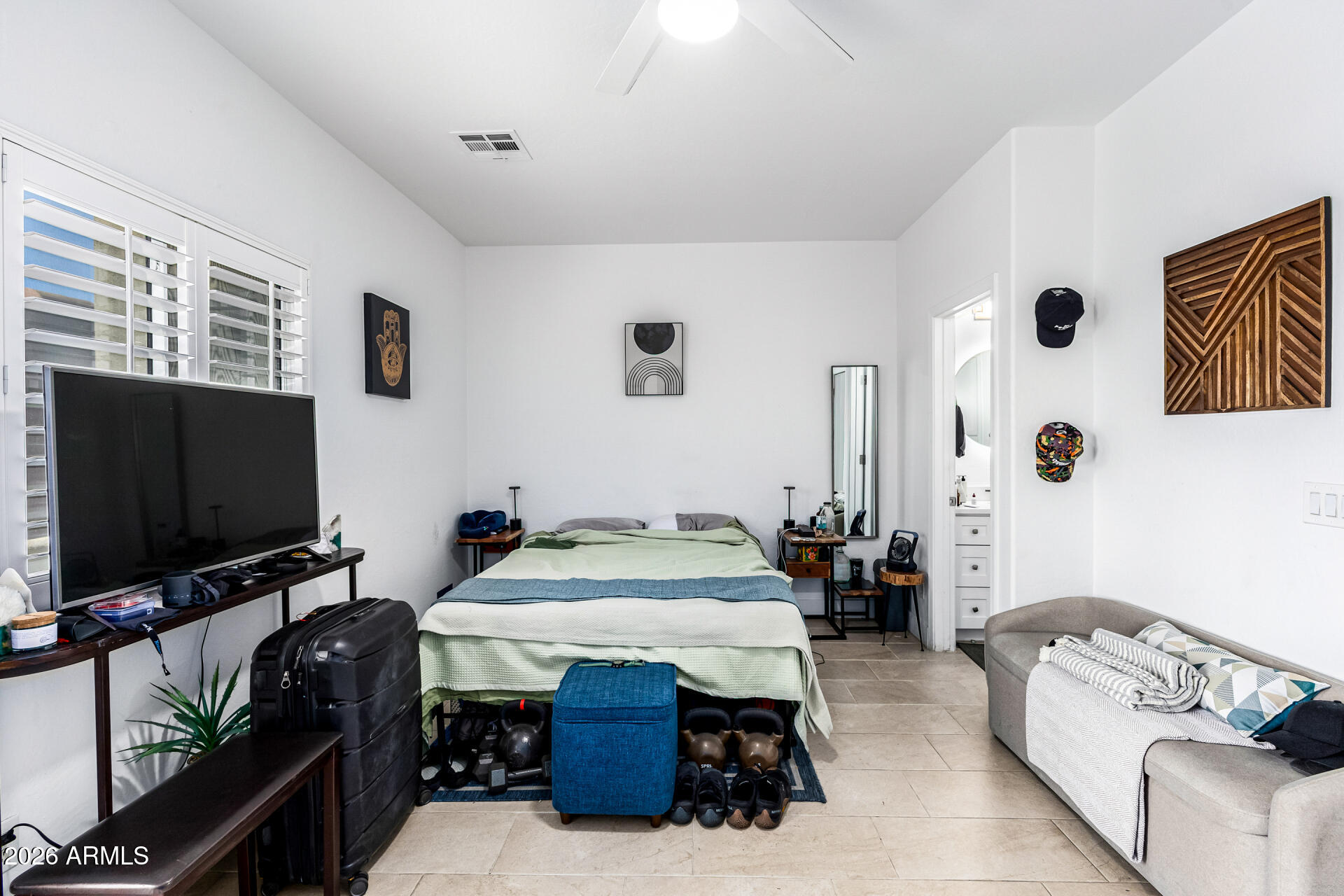 1718 West Colter Street, Unit 115 Phoenix, AZ 85015 - Photo 18 of 26 a bedroom with furniture and a flat screen tv
