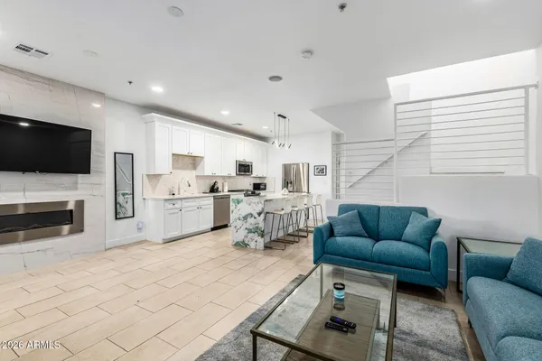 a living room with furniture a flat screen tv and a fireplace