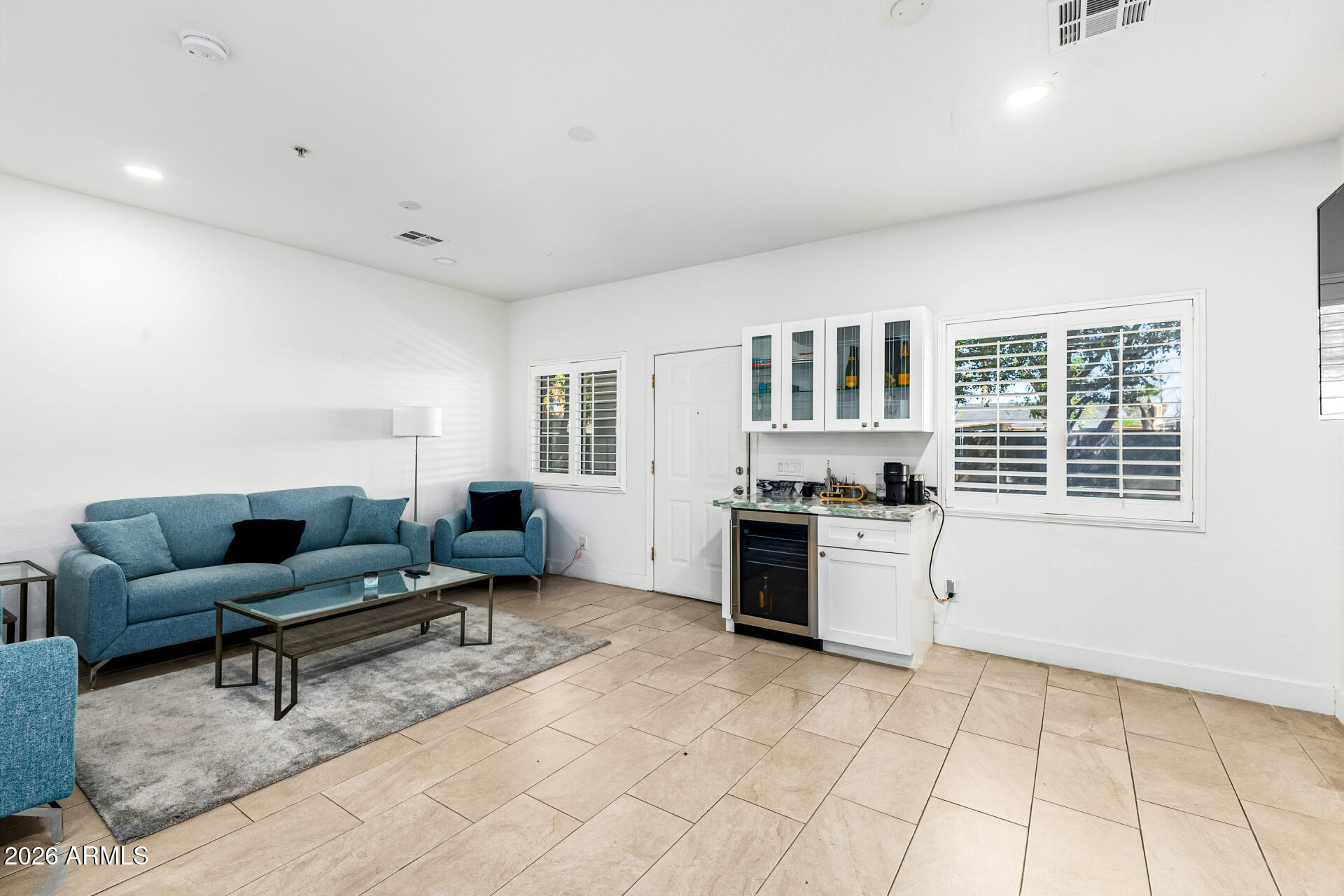 1718 West Colter Street, Unit 115 Phoenix, AZ 85015 - Photo 5 of 26 a living room with furniture and kitchen view