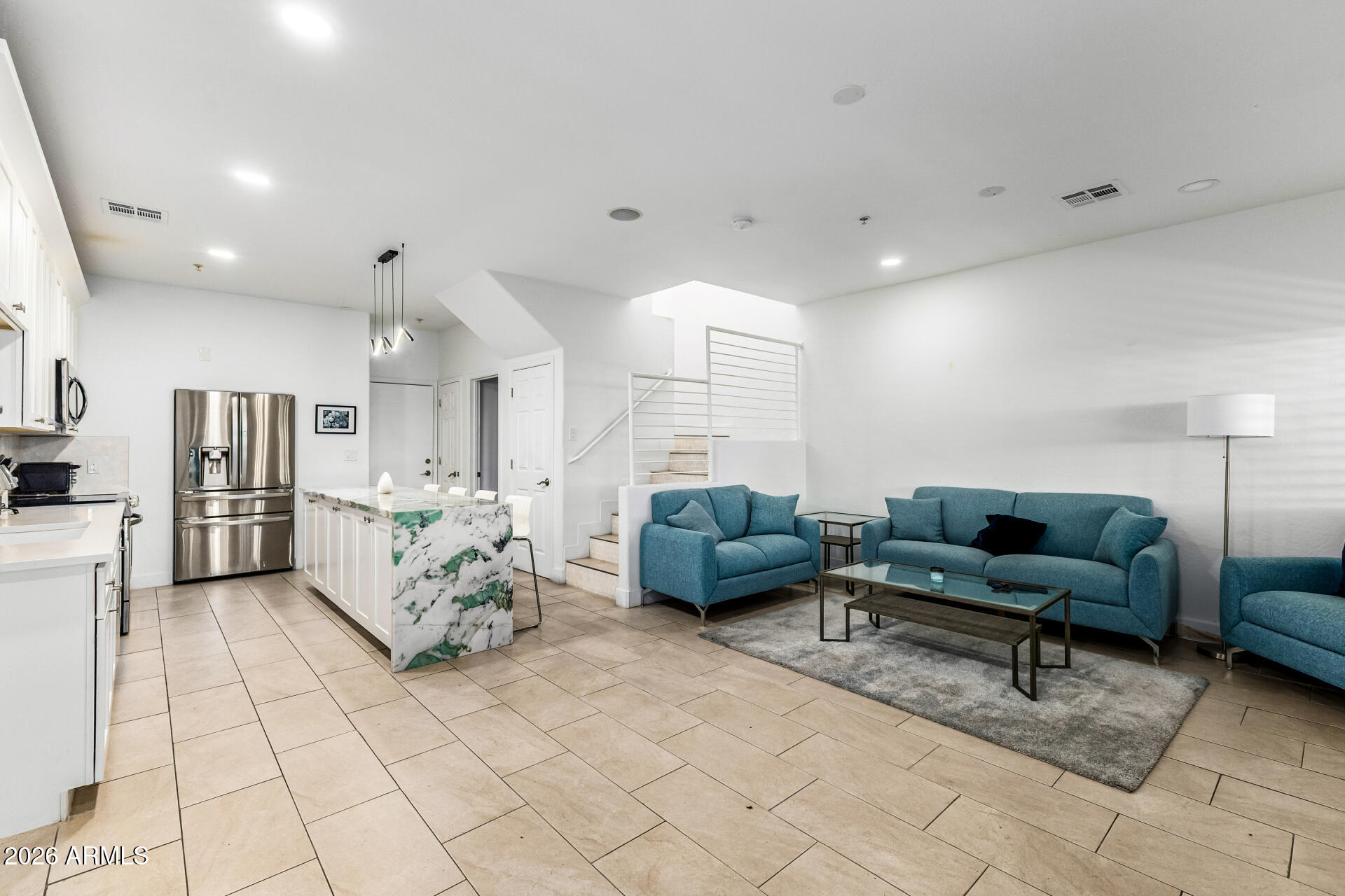 1718 West Colter Street, Unit 115 Phoenix, AZ 85015 - Photo 6 of 26 a living room with furniture and a couch