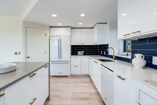 a kitchen with stainless steel appliances granite countertop a sink and cabinets
