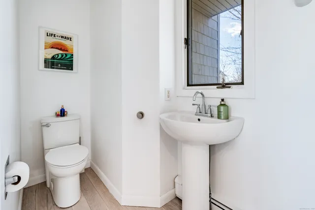 a bathroom with a toilet sink and mirror