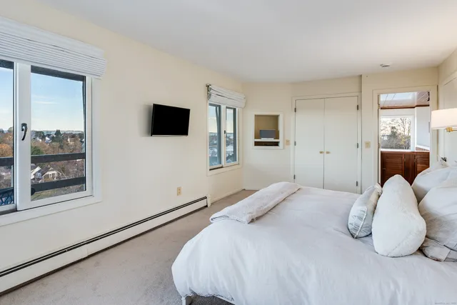 a bedroom with a bed and a large window