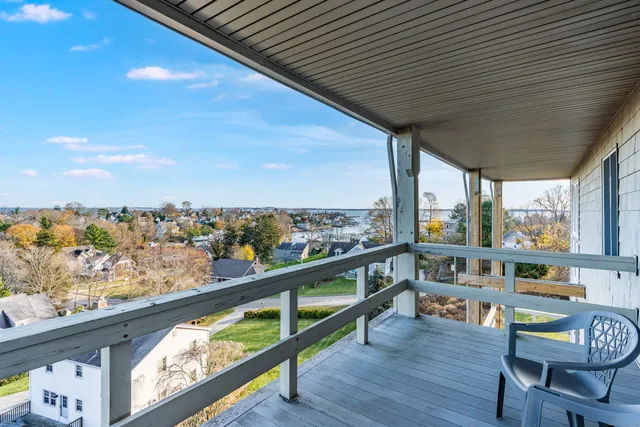 a view of a city from a balcony with furniture