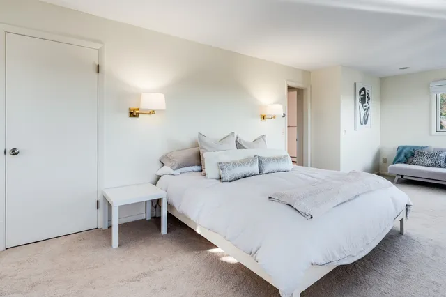 a bedroom with bed and a window