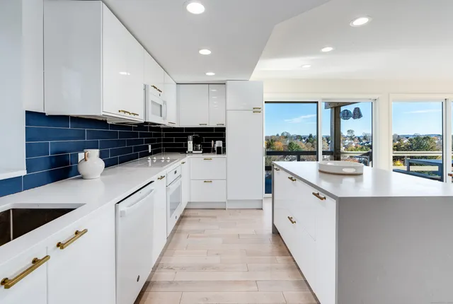 a kitchen with granite countertop a sink and a stove