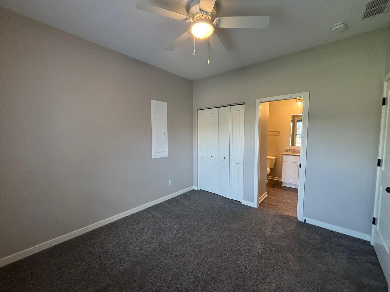 608 Anjali Court, Unit L Sycamore, IL 60178 - Photo 14 of 26 an empty room and chandelier fan in a room