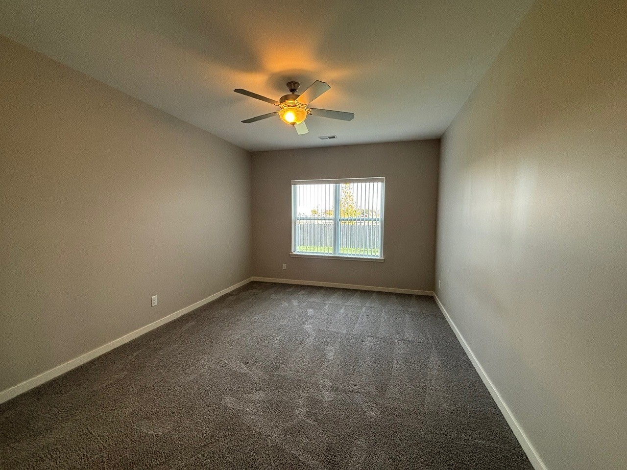 608 Anjali Court, Unit L Sycamore, IL 60178 - Photo 18 of 26 an empty room with windows and fan