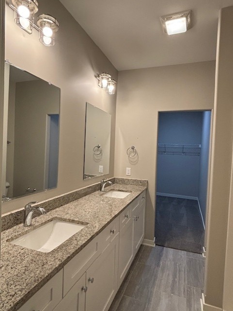 608 Anjali Court, Unit L Sycamore, IL 60178 - Photo 20 of 26 a bathroom with a granite countertop sink and a mirror