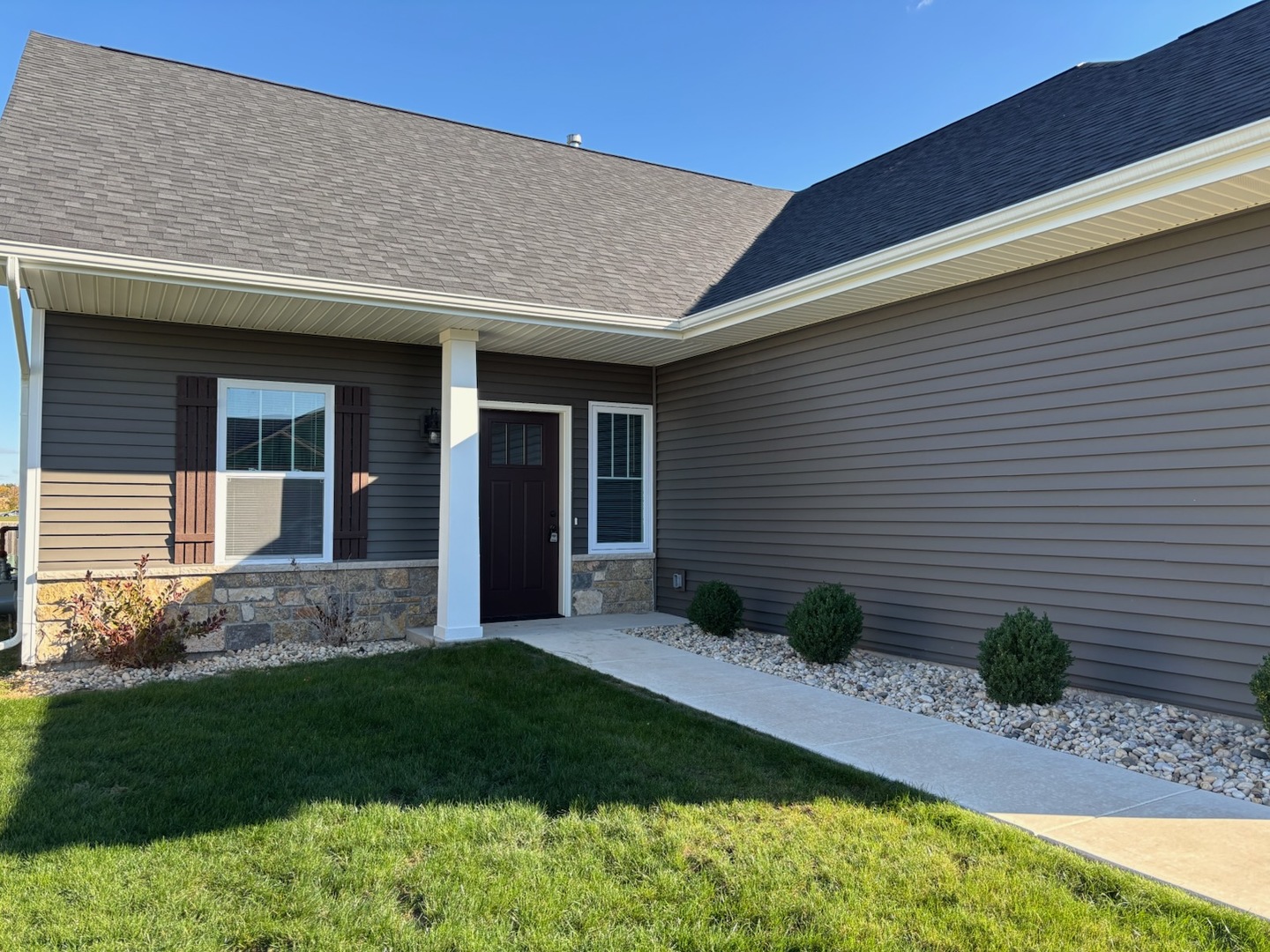 608 Anjali Court, Unit L Sycamore, IL 60178 - Photo 3 of 26 a view of a house with a yard and plants