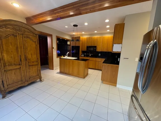 a view of kitchen with refrigerator and cabinets