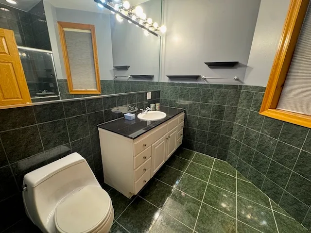 a bathroom with a sink toilet and mirror