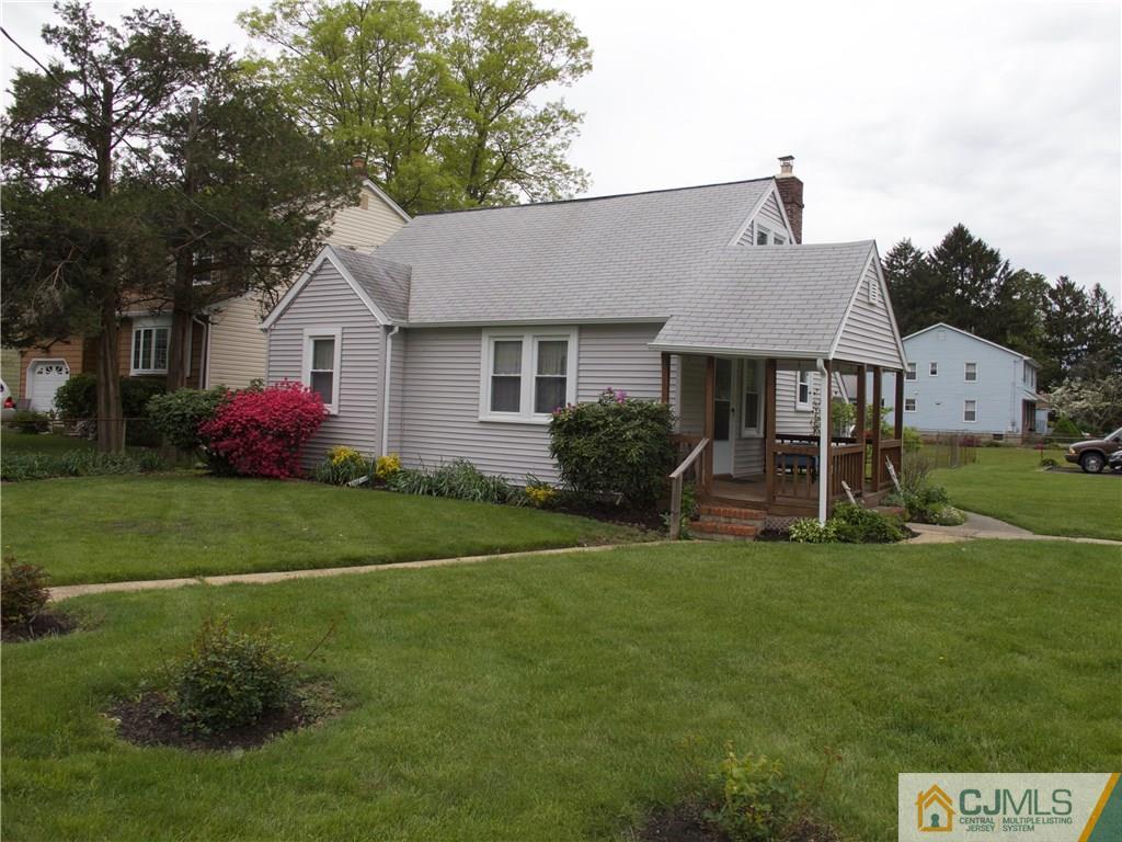 1707 Holly Road North Brunswick, NJ 08902 - Photo 2 of 21 a front view of a house with a garden and yard
