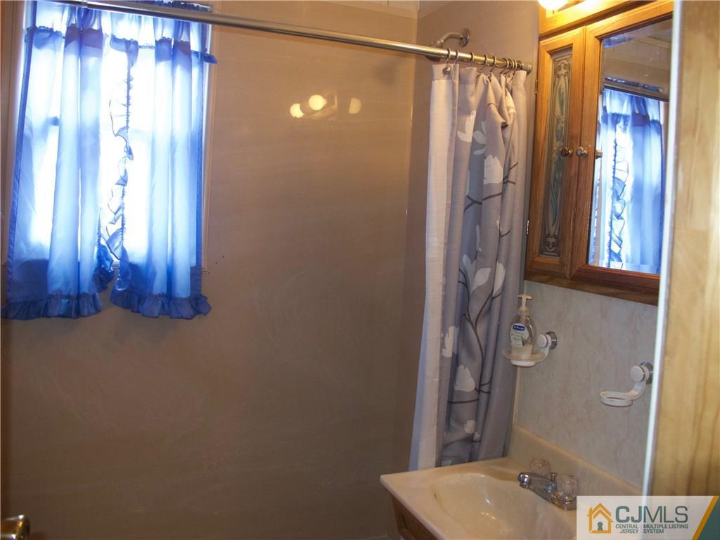 1707 Holly Road North Brunswick, NJ 08902 - Photo 11 of 21 a bathroom with a shower and a sink