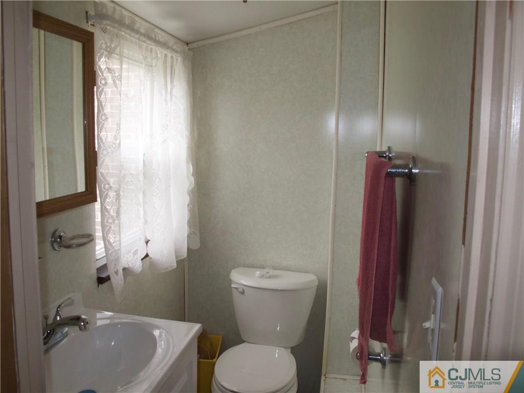 1707 Holly Road North Brunswick, NJ 08902 - Photo 15 of 21 a bathroom with a sink a toilet and shower