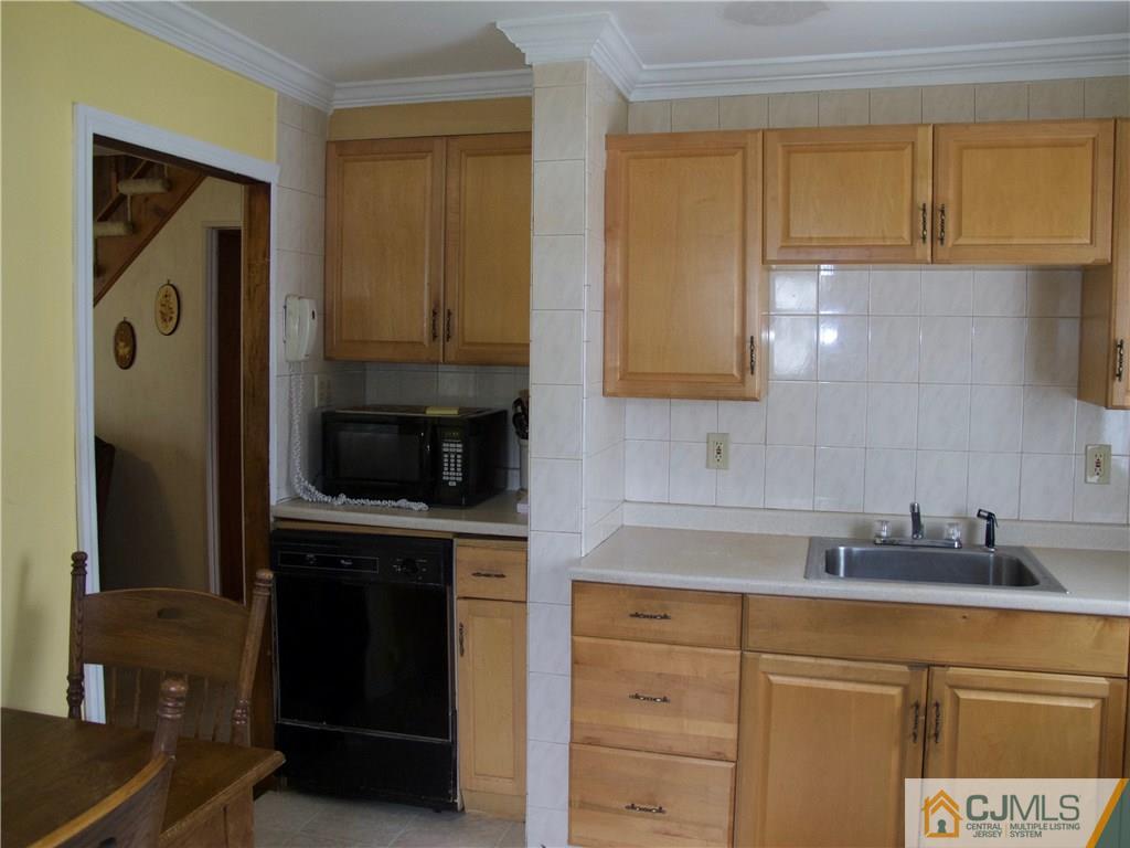 1707 Holly Road North Brunswick, NJ 08902 - Photo 18 of 21 a kitchen with stainless steel appliances granite countertop a stove a sink and a microwave