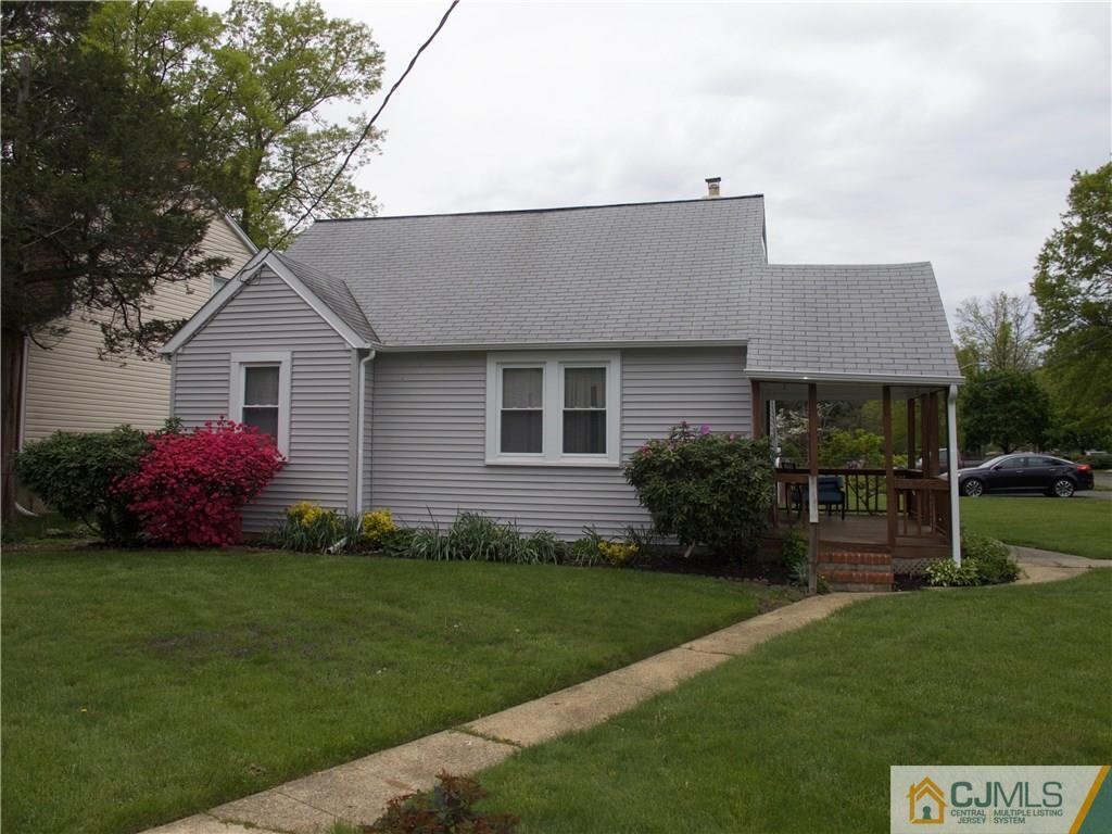 1707 Holly Road North Brunswick, NJ 08902 - Photo 3 of 21 a front view of a house with a garden and yard
