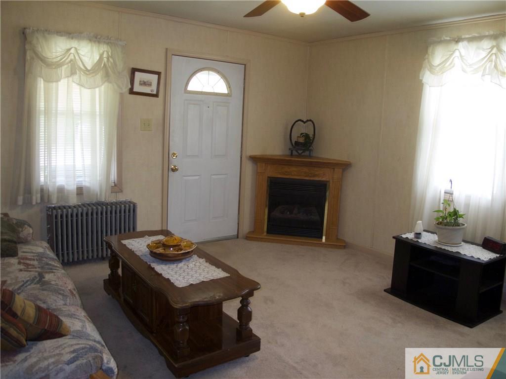 1707 Holly Road North Brunswick, NJ 08902 - Photo 7 of 21 a living room with furniture and a fireplace