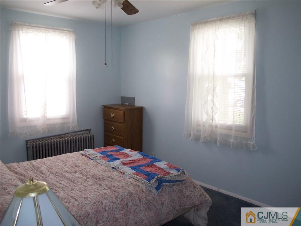 1707 Holly Road North Brunswick, NJ 08902 - Photo 10 of 21 a bedroom with a bed and a window