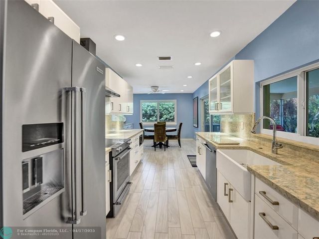 a kitchen with a sink appliances and cabinets