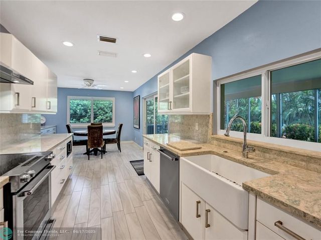 a kitchen with a sink and wooden cabinets