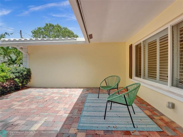 a view of a house with a yard and sitting area