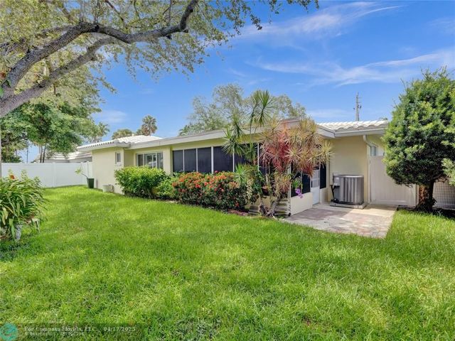 a view of backyard of house with green space
