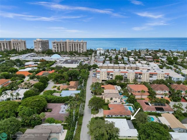 an aerial view of residential houses with city view