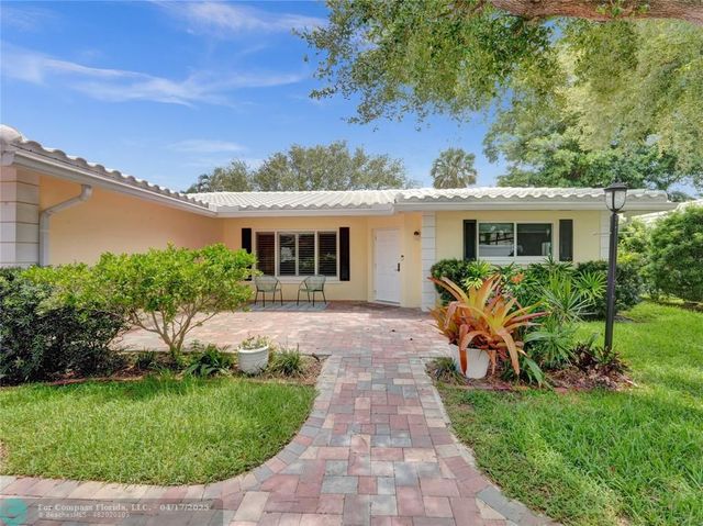a view of a house with a backyard and a patio