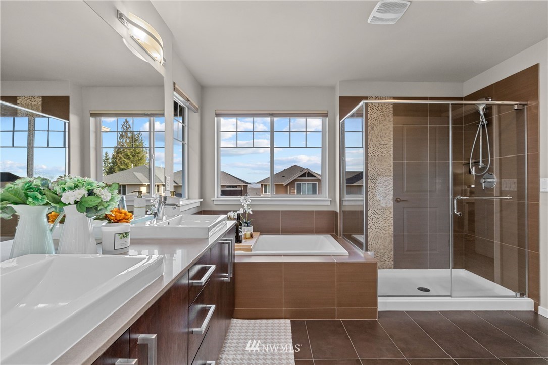 19208 101st Place Southeast Renton, WA 98055 - Photo 22 of 36 a bathroom with a tub a sink and large mirror