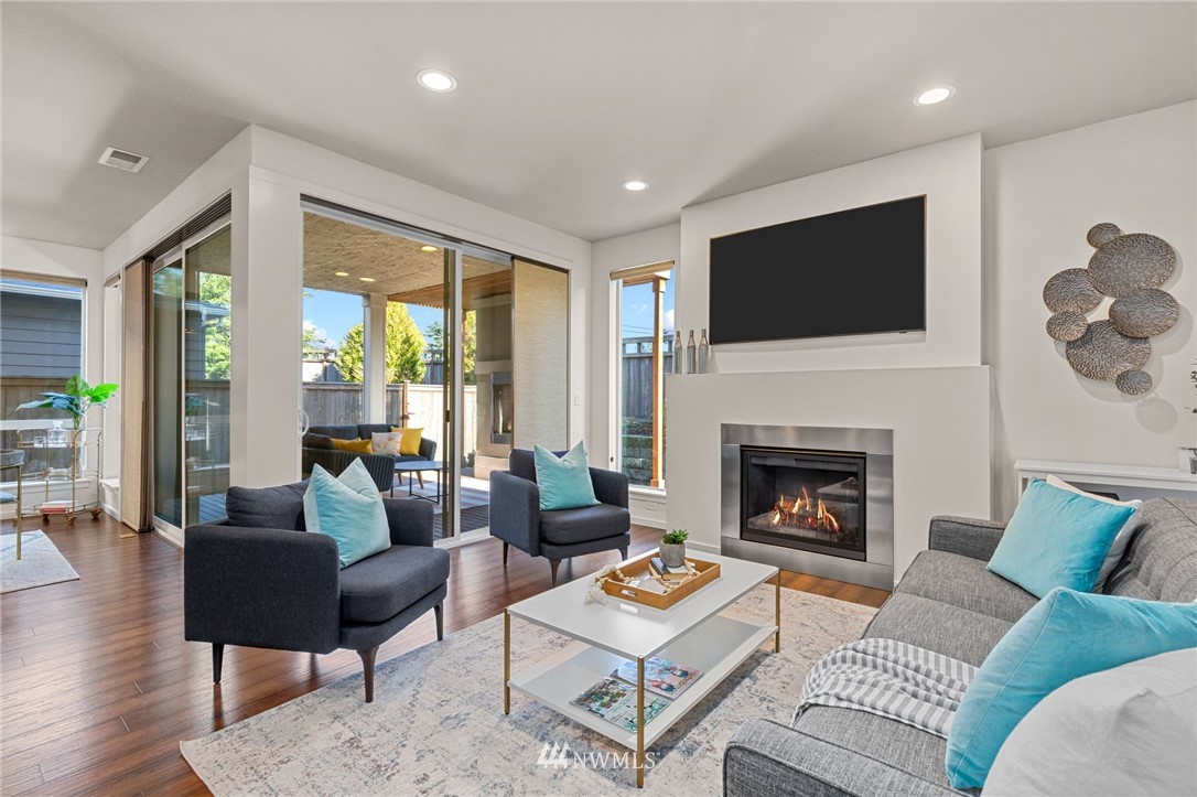 19208 101st Place Southeast Renton, WA 98055 - Photo 3 of 36 a living room with furniture a flat screen tv and a fireplace