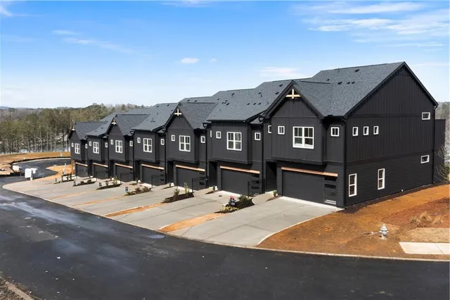 a view of a house with cars park