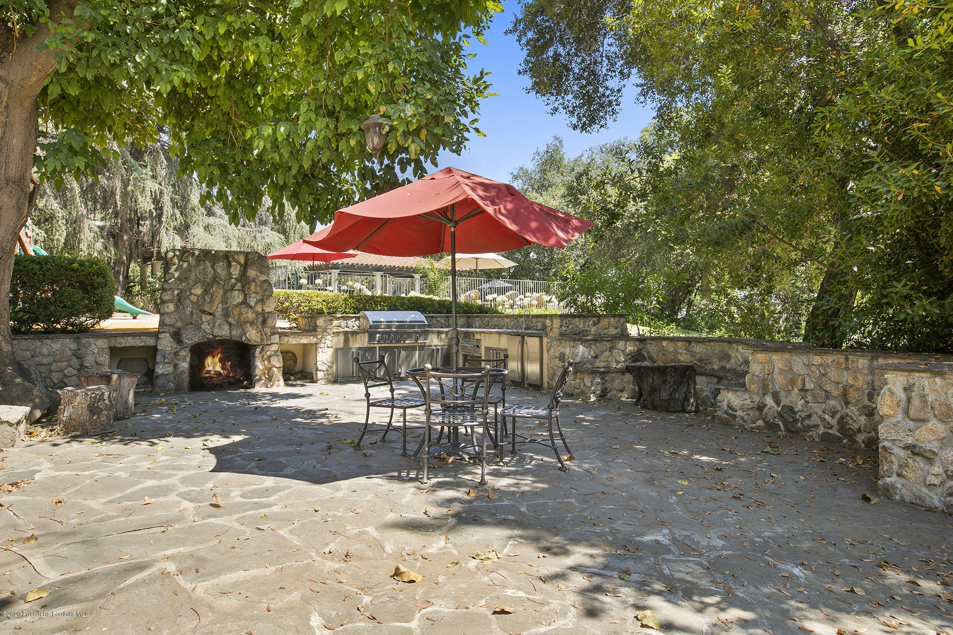 2288 Villa Heights Road Pasadena, CA 91107 - Photo 44 of 78 a view of a patio with a table and chairs under an umbrella