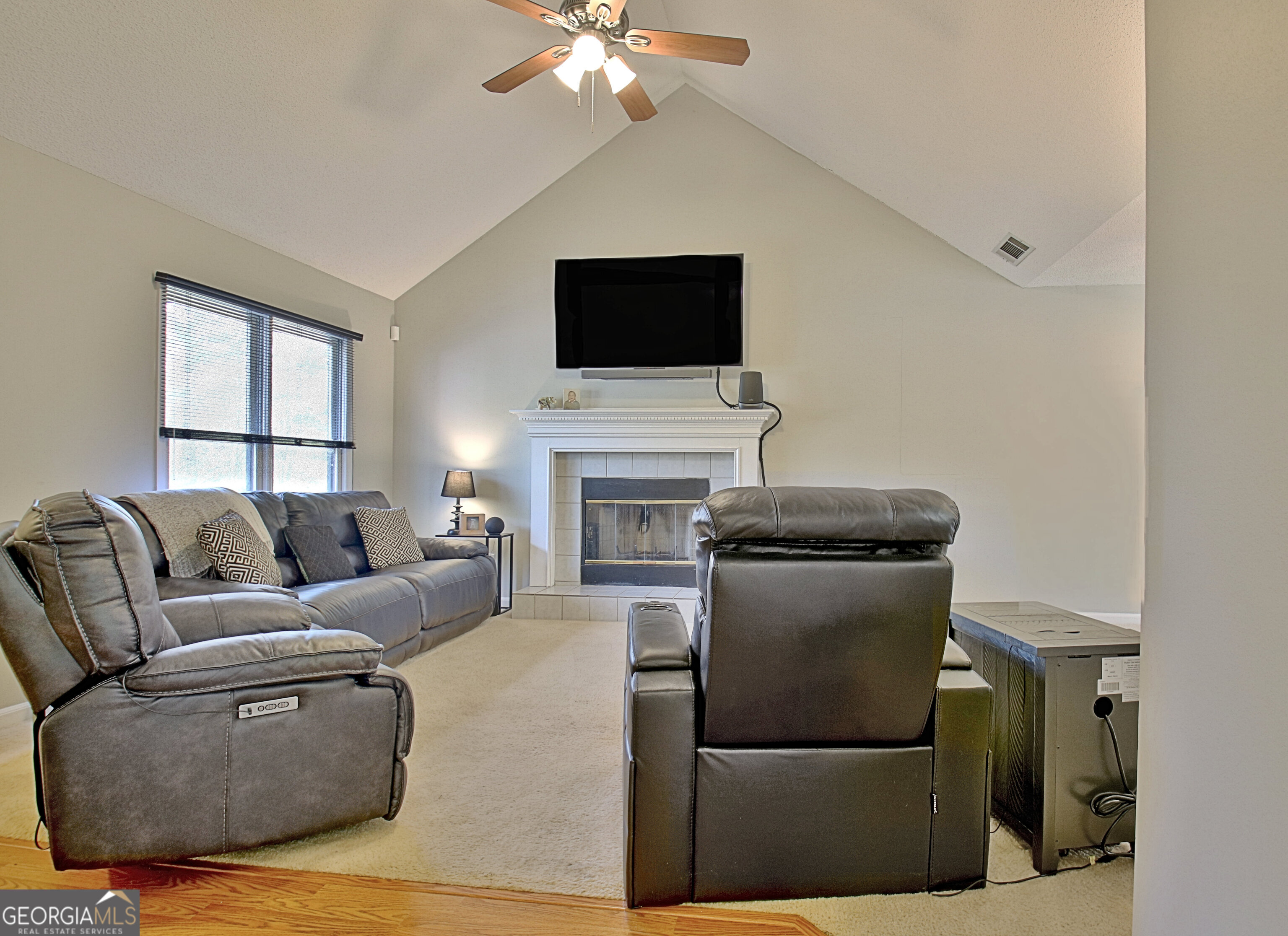 104 Blue Ridge Drive Newnan, GA 30265 - Photo 12 of 60 a living room with furniture a flat screen tv and a fireplace