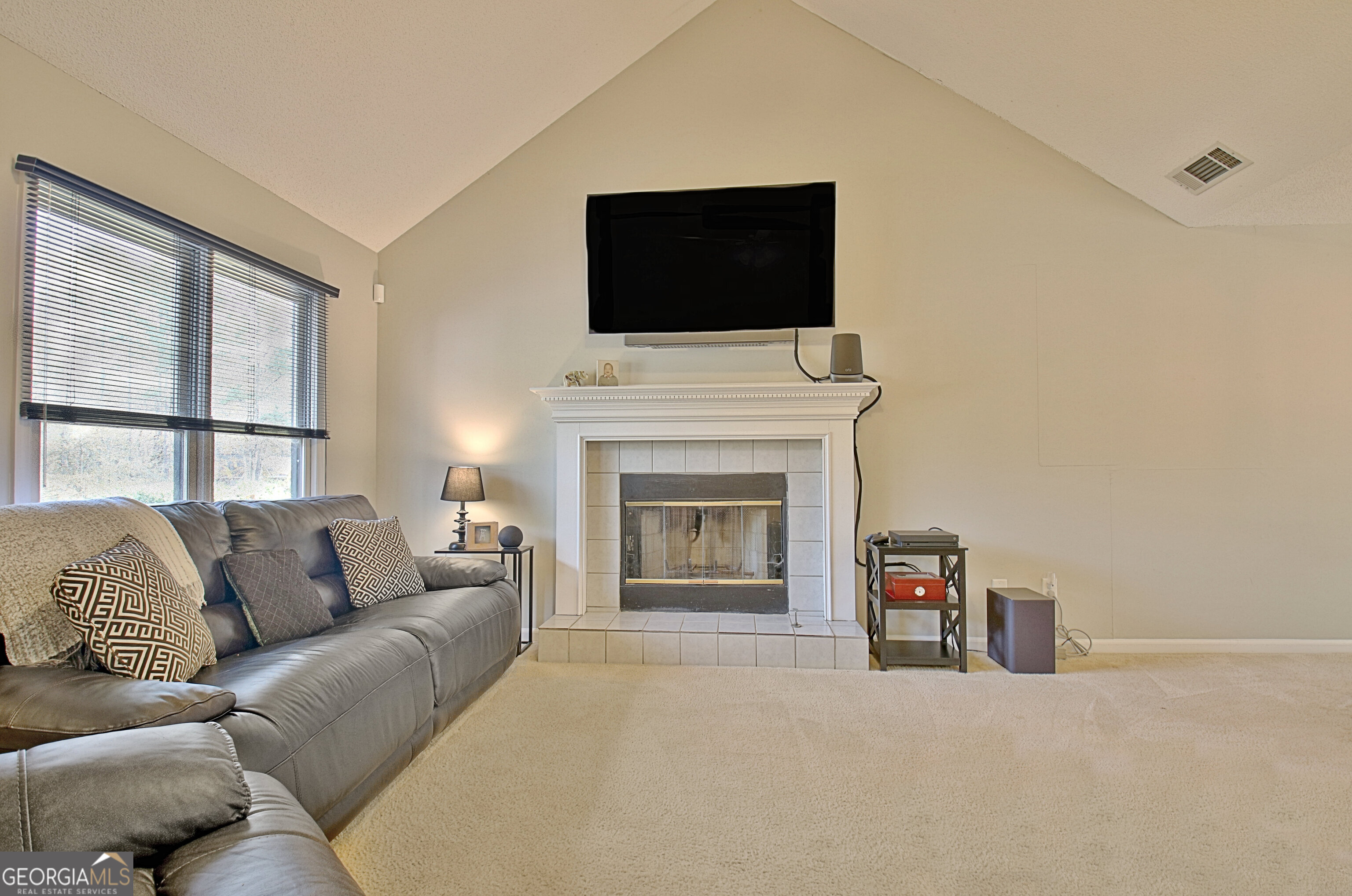 104 Blue Ridge Drive Newnan, GA 30265 - Photo 13 of 60 a living room with furniture a fireplace and a flat screen tv
