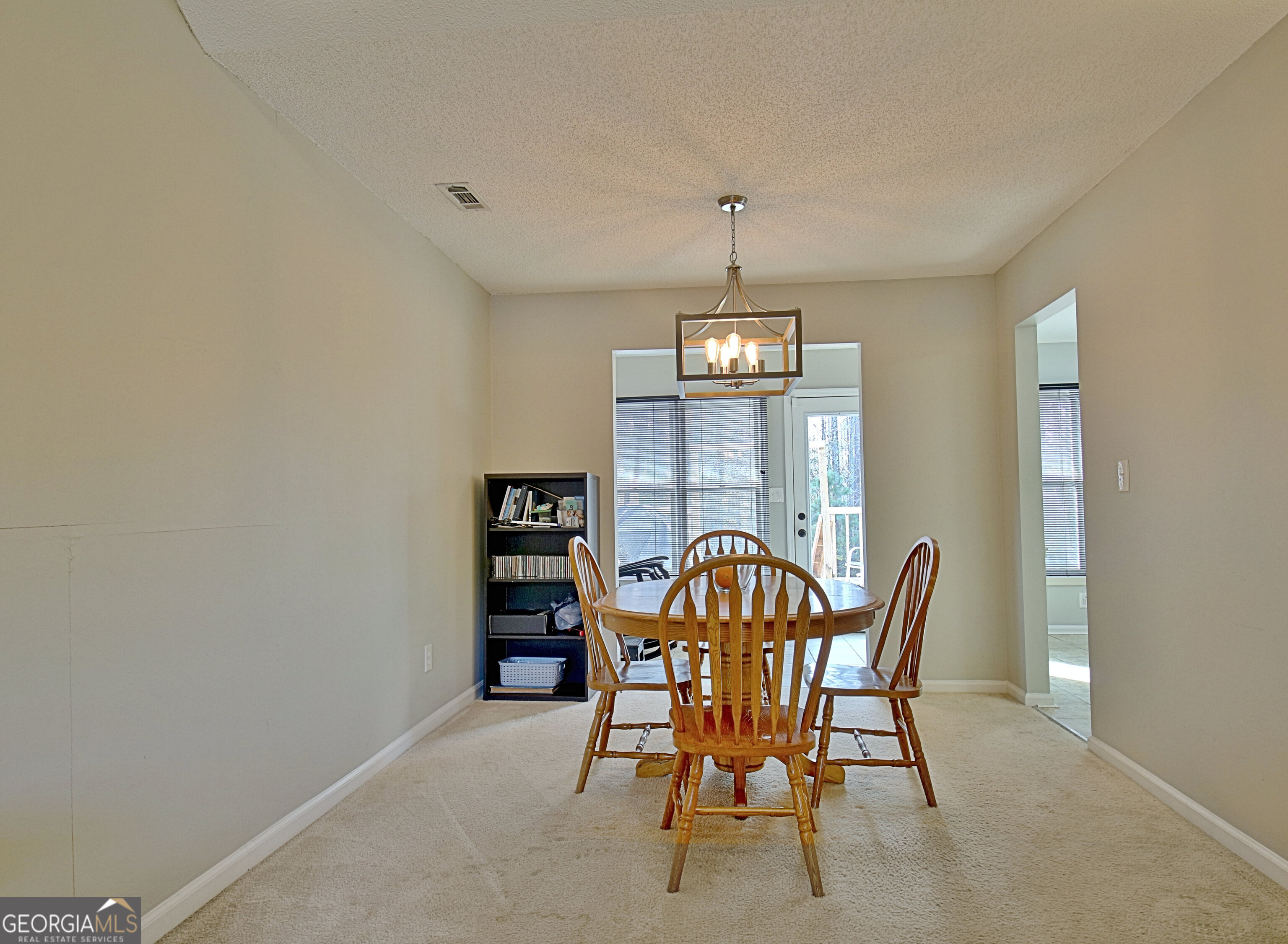 104 Blue Ridge Drive Newnan, GA 30265 - Photo 15 of 60 a view of a dining room with a table and chairs