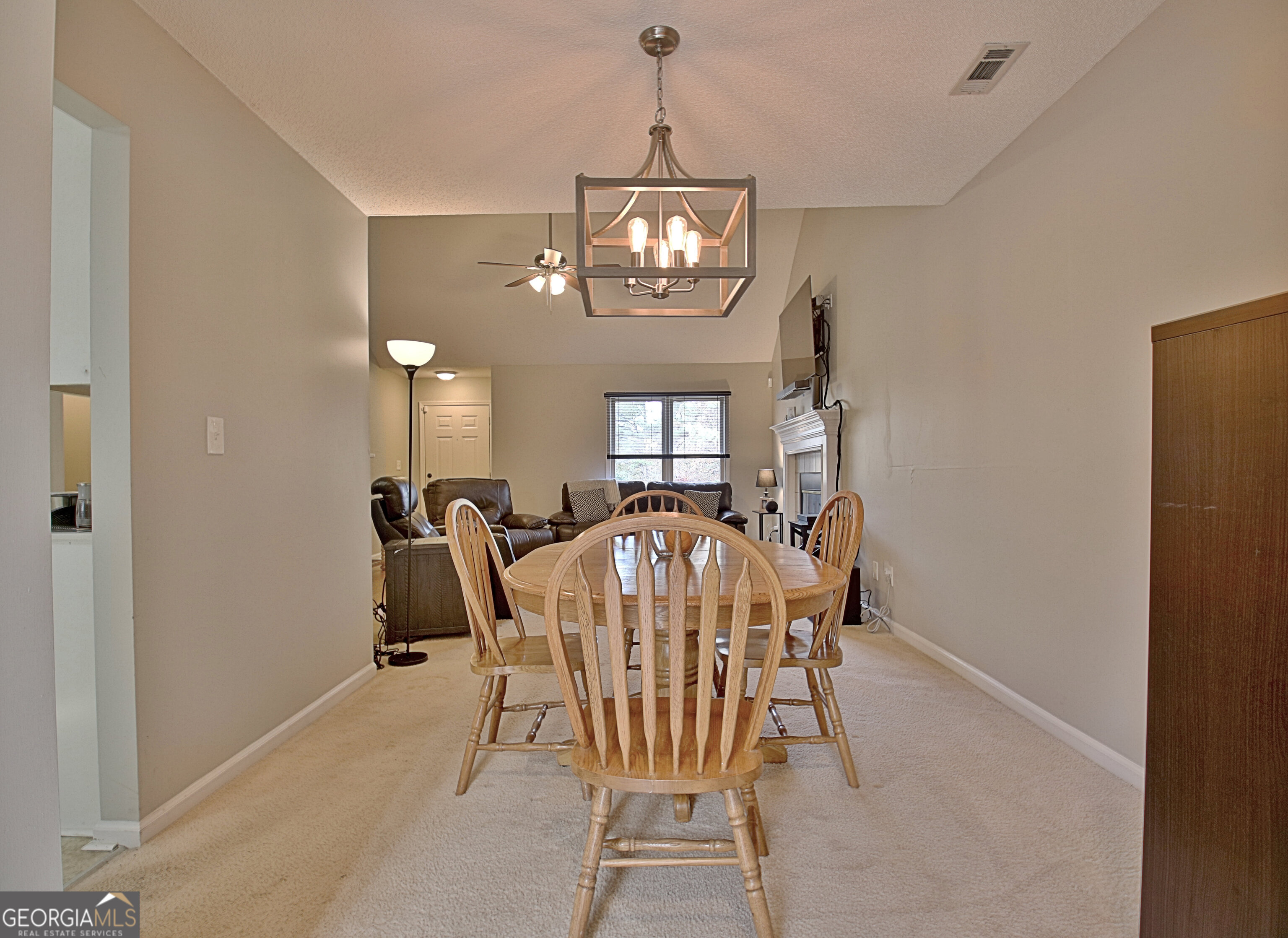 104 Blue Ridge Drive Newnan, GA 30265 - Photo 16 of 60 a view of a dining room with furniture and a chandelier
