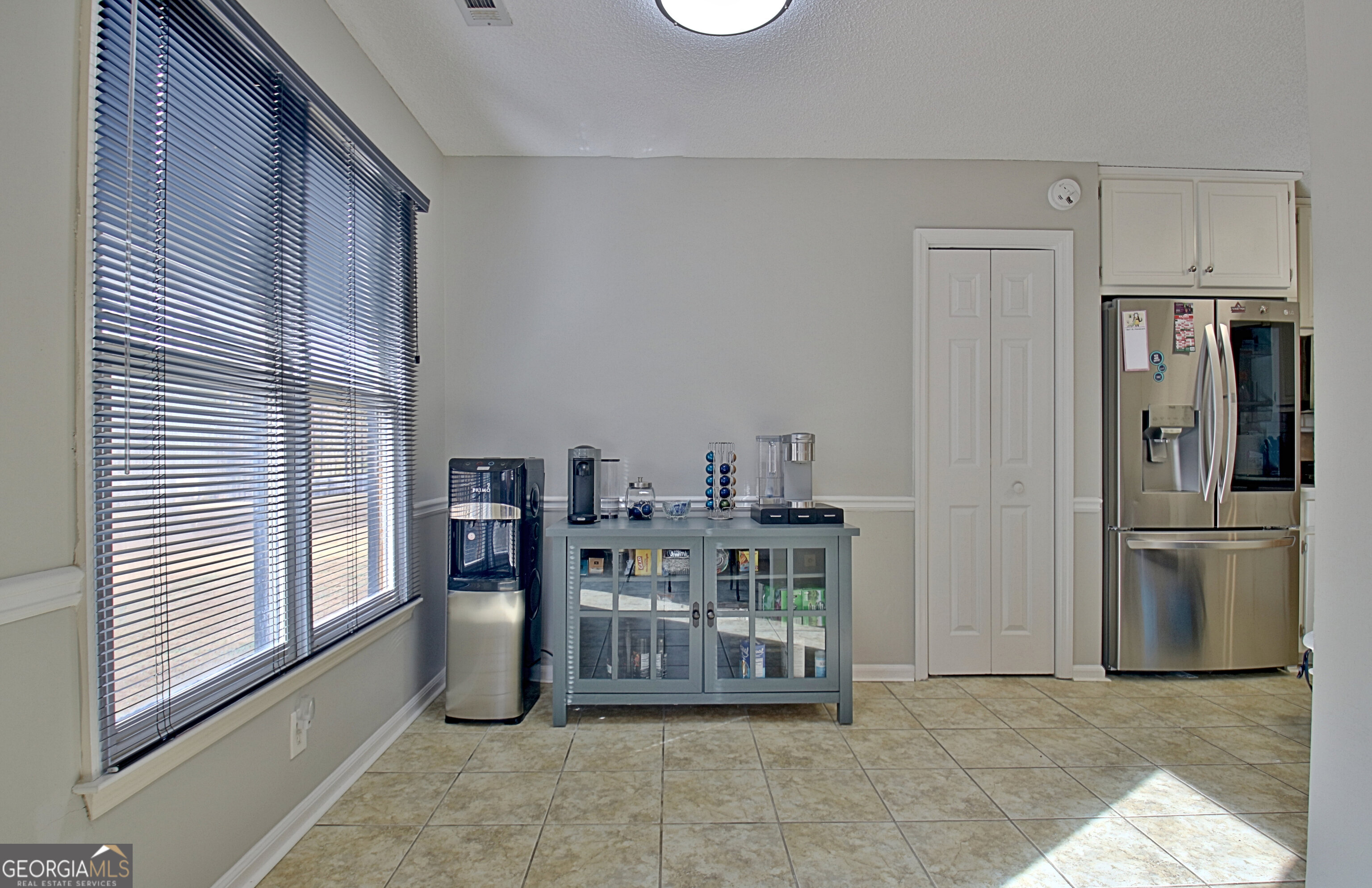 104 Blue Ridge Drive Newnan, GA 30265 - Photo 22 of 60 a view of a kitchen with refrigerator and chairs
