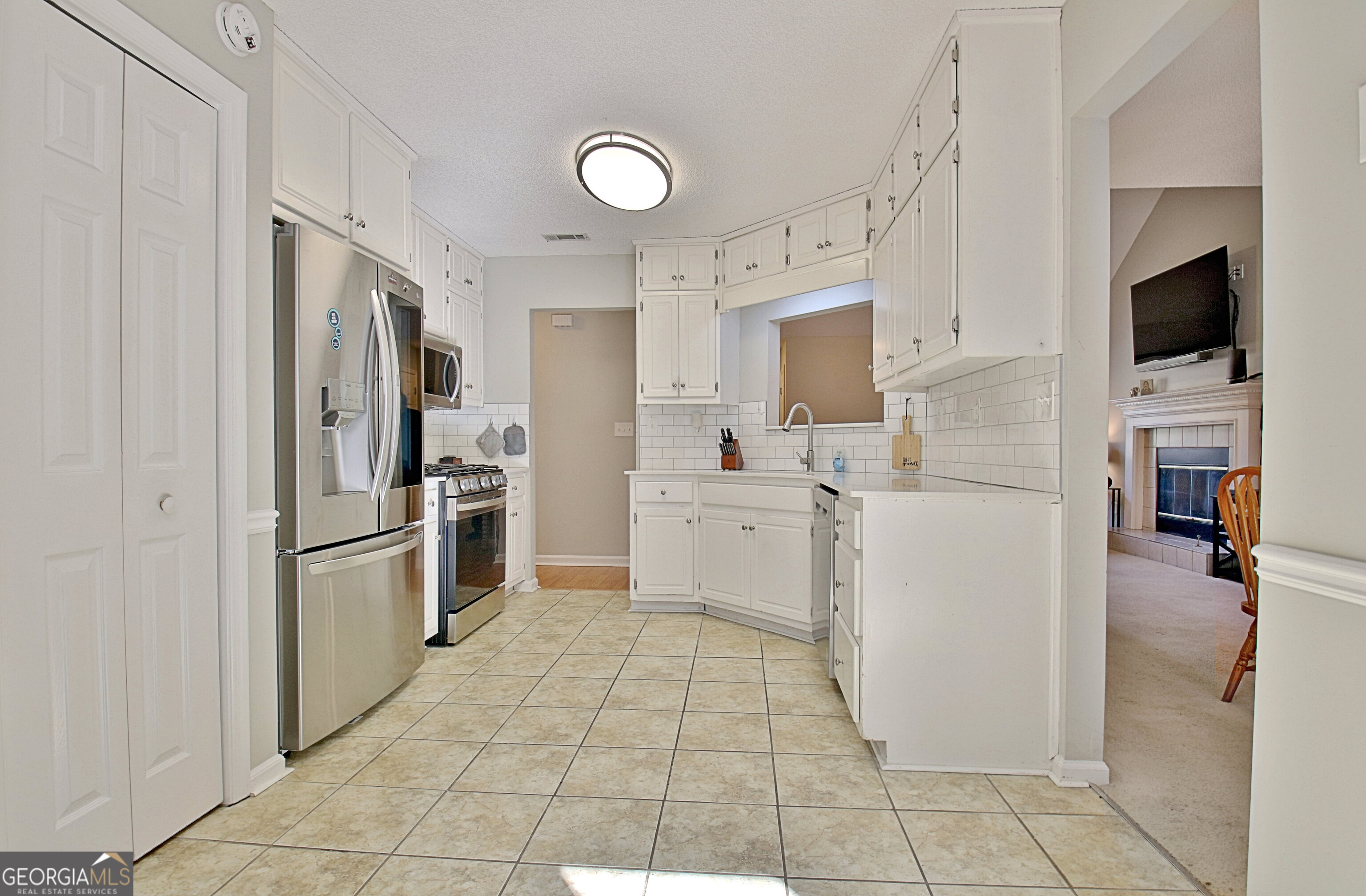 104 Blue Ridge Drive Newnan, GA 30265 - Photo 23 of 60 a kitchen with a refrigerator sink and cabinets