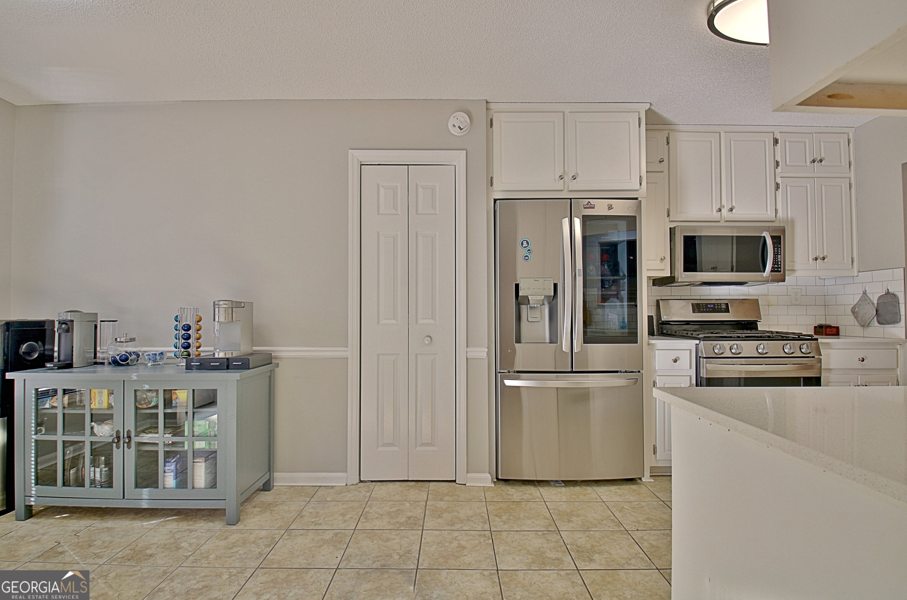 104 Blue Ridge Drive Newnan, GA 30265 - Photo 24 of 60 a kitchen with stainless steel appliances a refrigerator stove and microwave