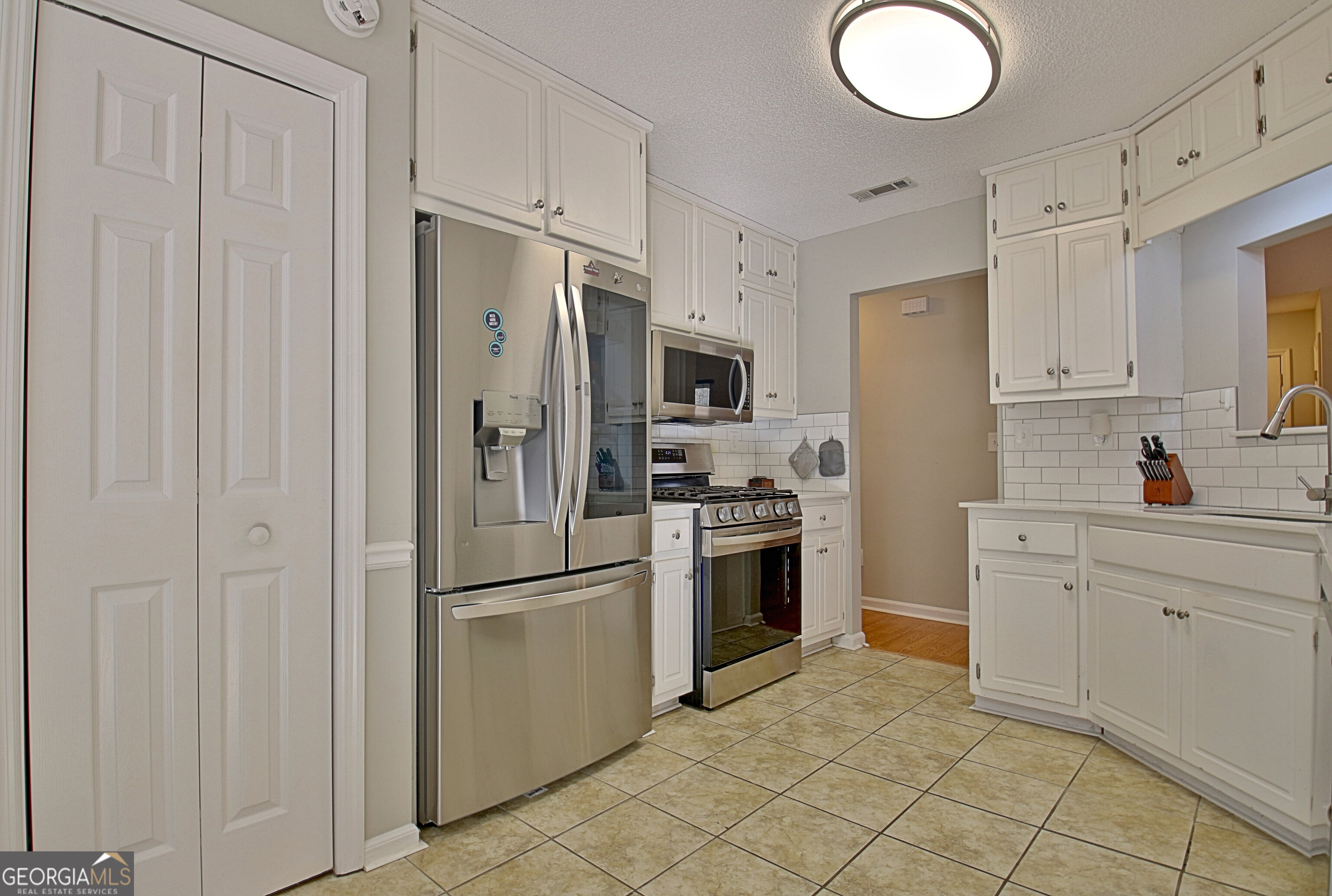 104 Blue Ridge Drive Newnan, GA 30265 - Photo 27 of 60 a kitchen with cabinets stainless steel appliances and a counter space