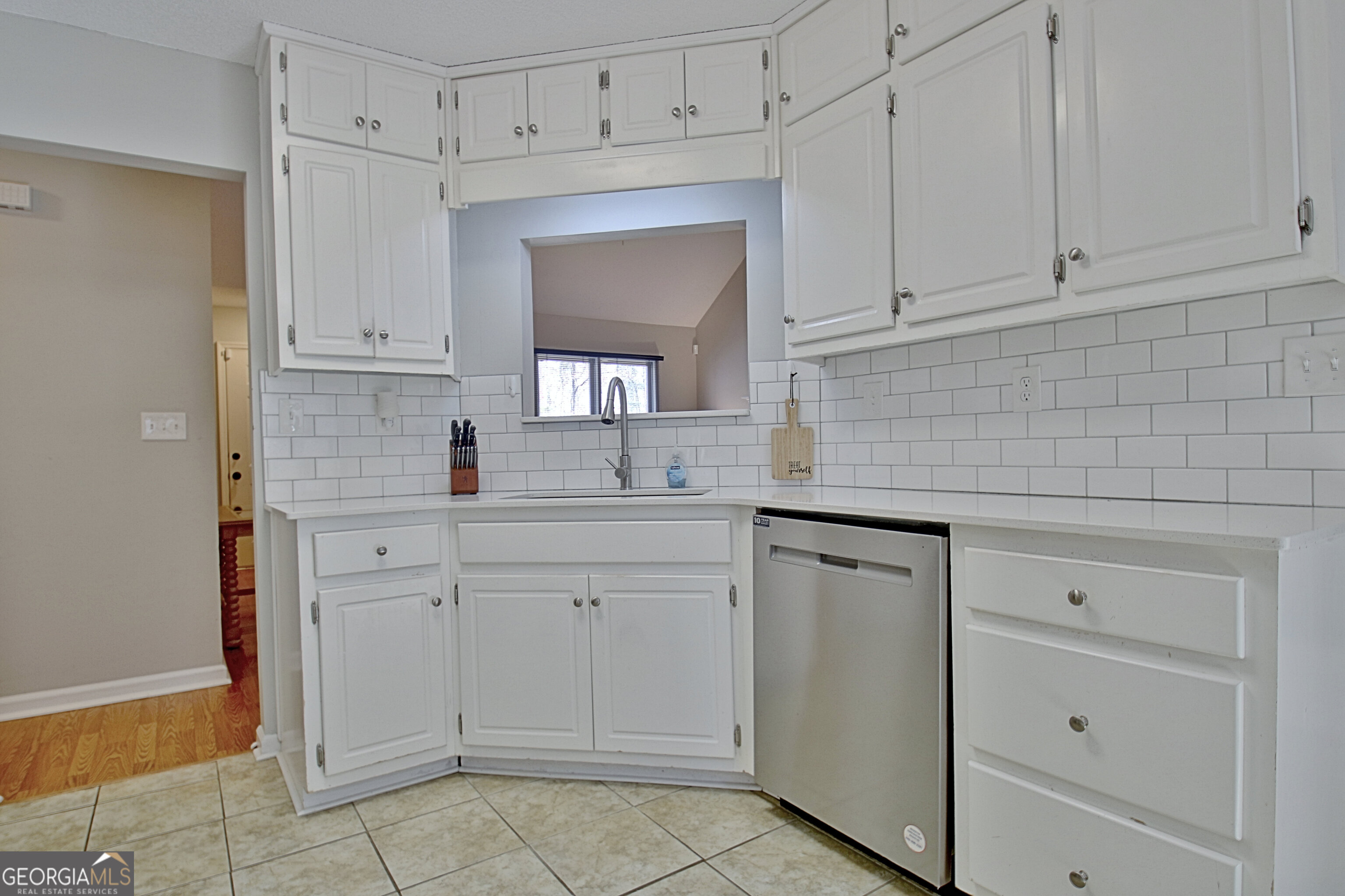 104 Blue Ridge Drive Newnan, GA 30265 - Photo 28 of 60 a kitchen with white cabinets and white appliances