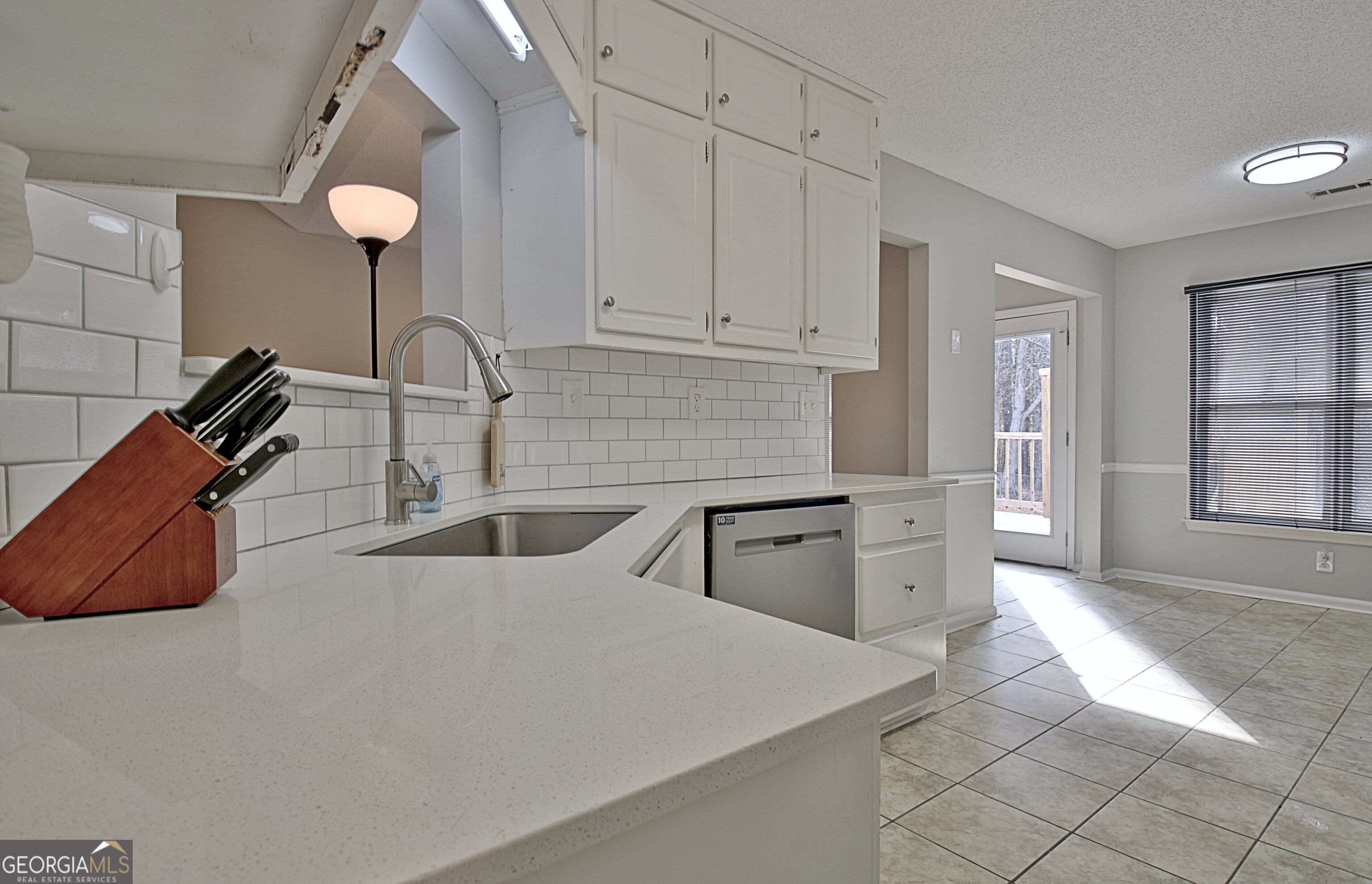 104 Blue Ridge Drive Newnan, GA 30265 - Photo 3 of 60 a kitchen with stainless steel appliances a sink stove and cabinets