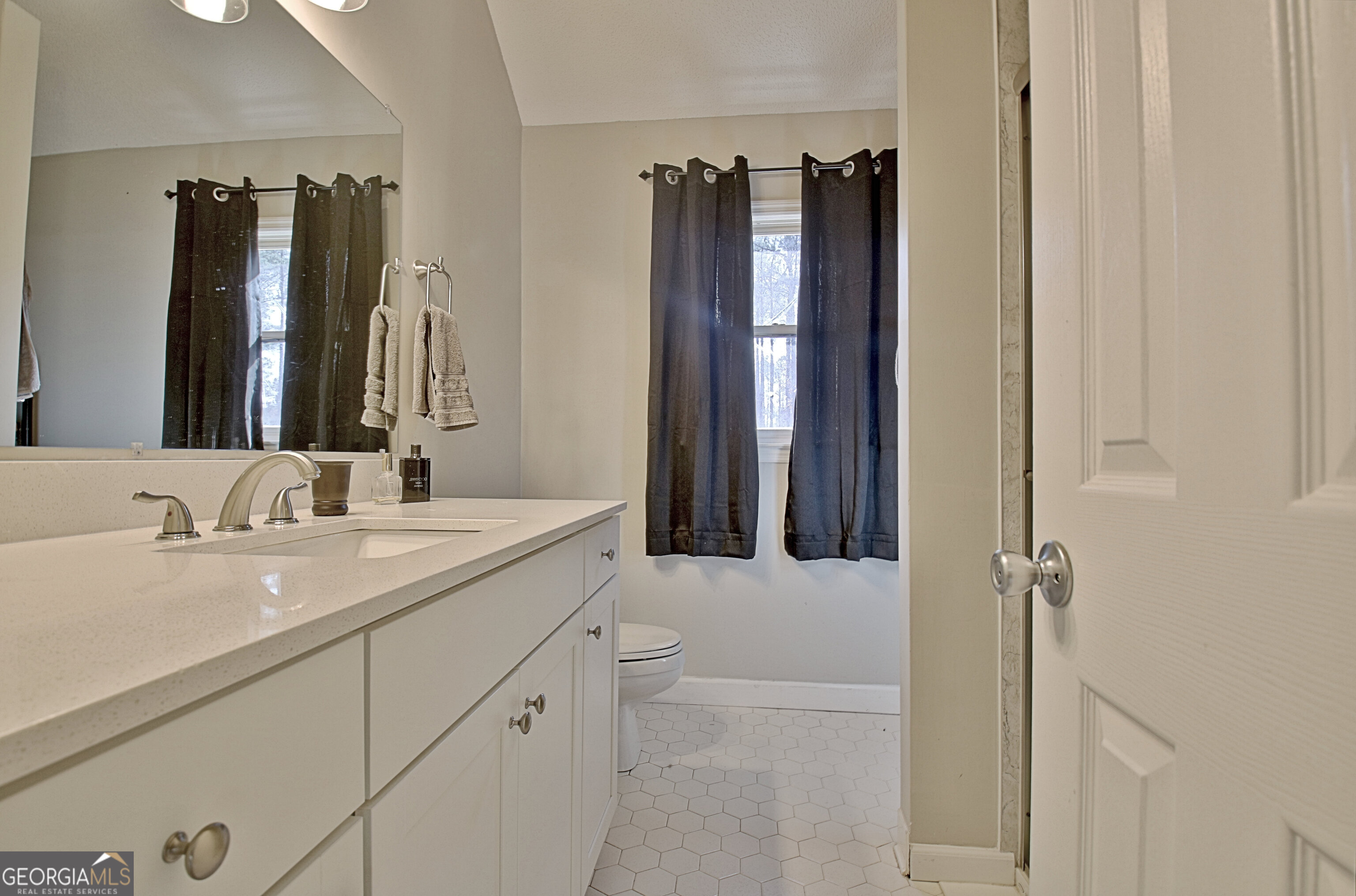 104 Blue Ridge Drive Newnan, GA 30265 - Photo 34 of 60 a bathroom with a double vanity sink and mirror