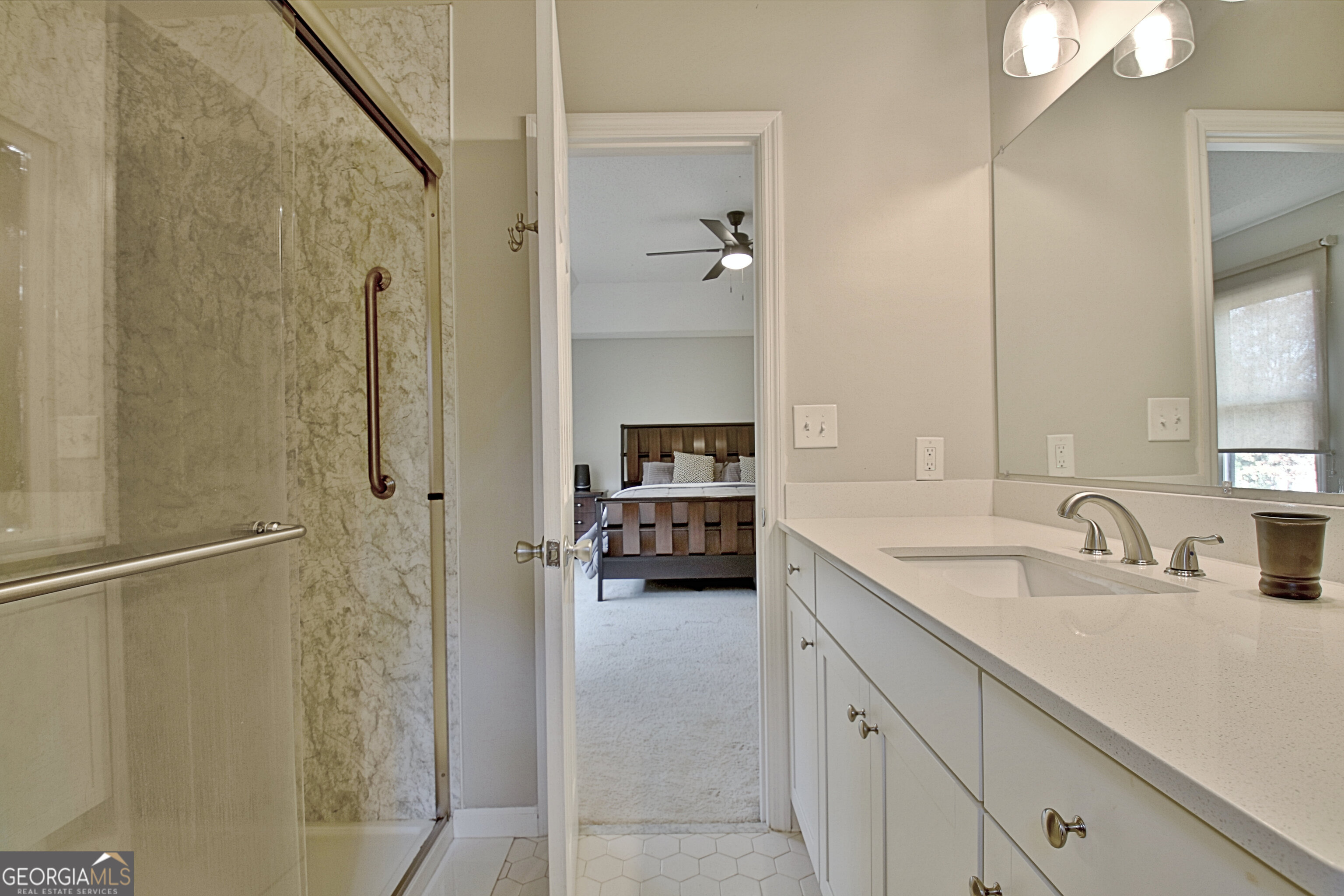 104 Blue Ridge Drive Newnan, GA 30265 - Photo 38 of 60 a en suite bathroom with a sink and a mirror