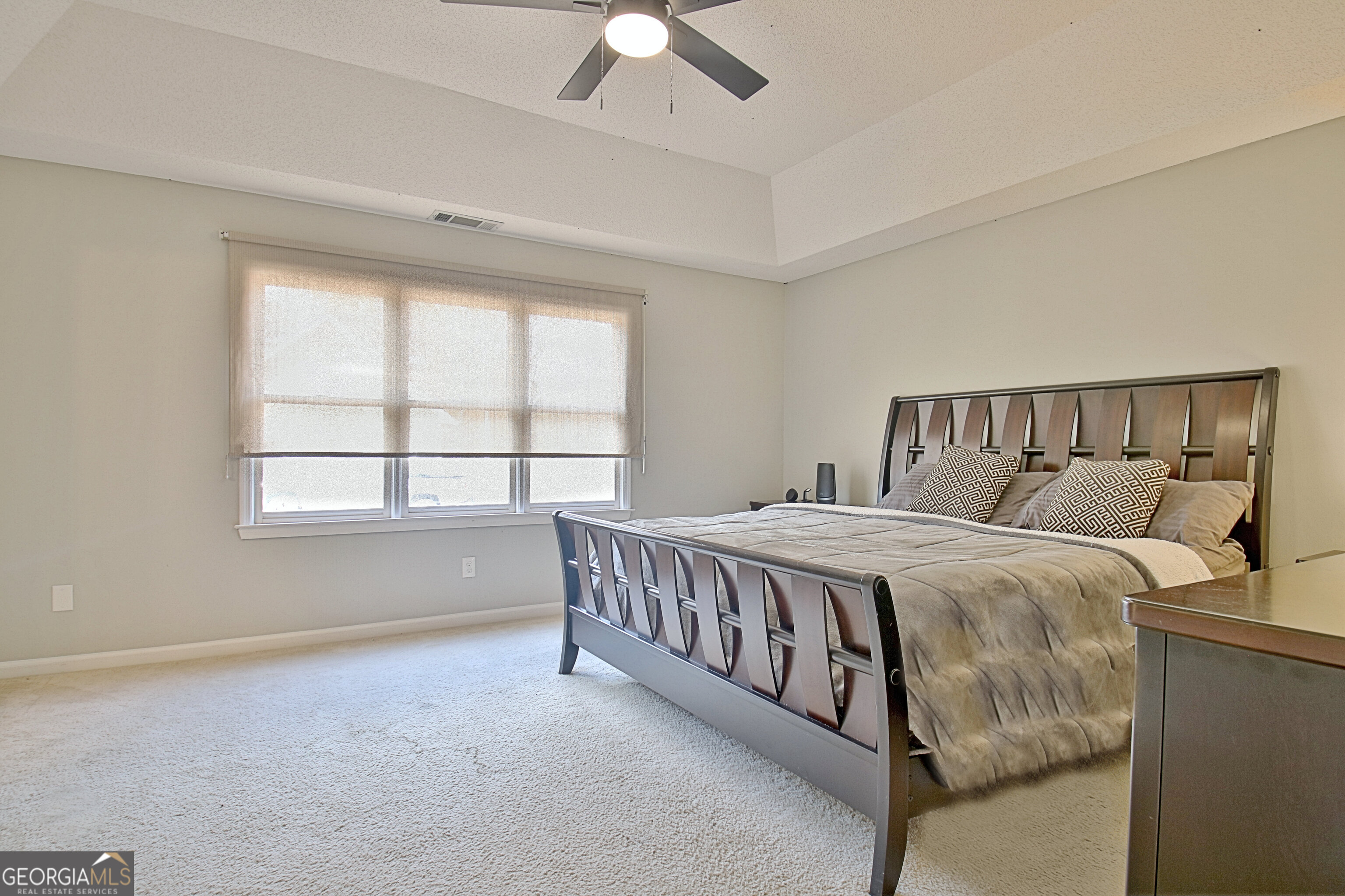 104 Blue Ridge Drive Newnan, GA 30265 - Photo 4 of 60 a bed sitting in a bedroom next to a window