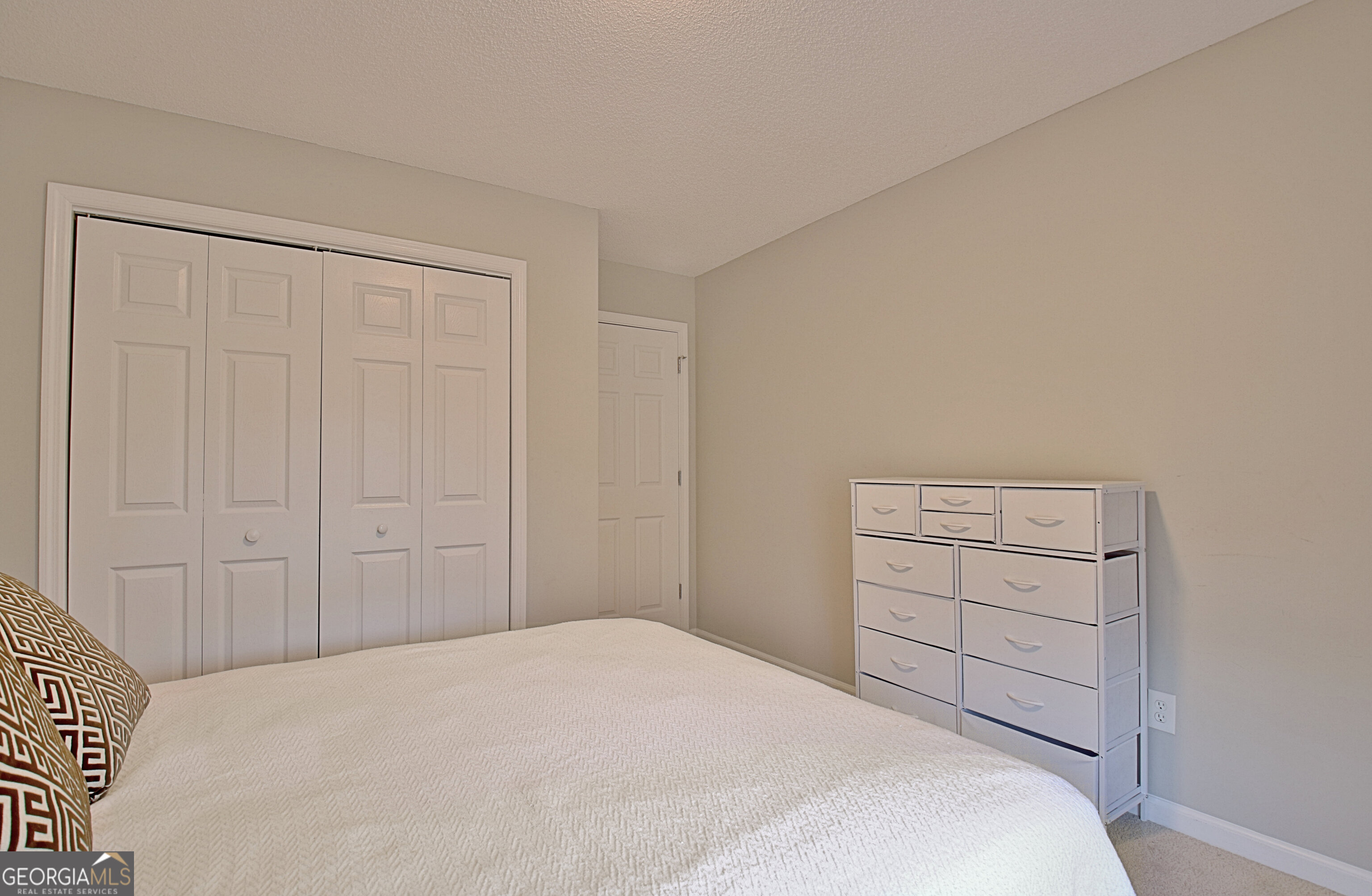 104 Blue Ridge Drive Newnan, GA 30265 - Photo 43 of 60 a bedroom with a bed and a cabinets